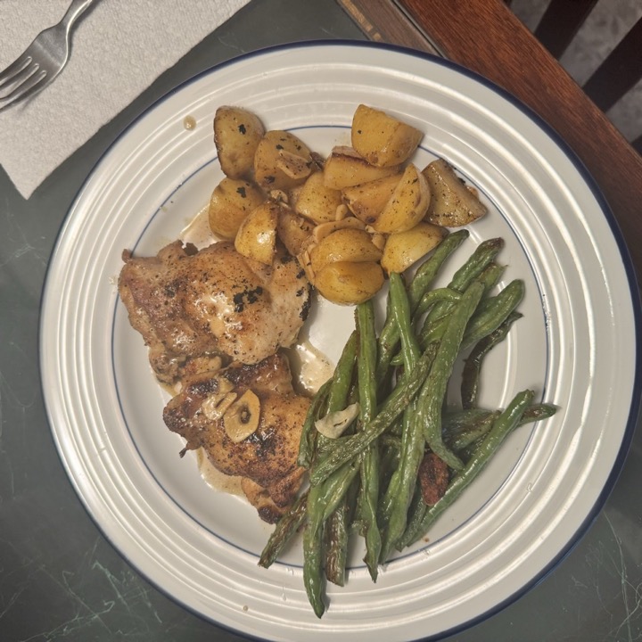 Close-up of the crispy lemon chicken thighs and roasted potatoes