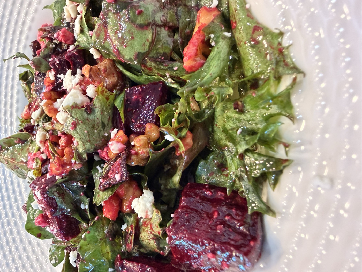 Beet salad with feta, toasted walnuts, and vinaigrette over mixed greens
